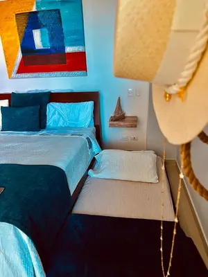 a bedroom with two beds and a lamp at MORROS VITRI Luxury in Cartagena de Indias