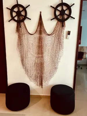 a wall with two black stools and two ships at MORROS VITRI Luxury in Cartagena de Indias