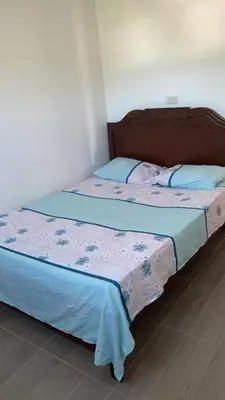 a bedroom with two beds with blue and pink sheets at Casa Vecchio in Cartagena de Indias