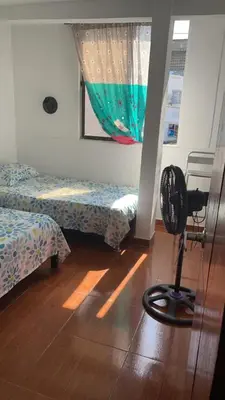 a room with two beds and a fan on the floor at Casa Vecchio in Cartagena de Indias