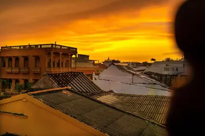 a view of a city at sunset with roofs at Life is Good Cartagena Hostel in Cartagena de Indias