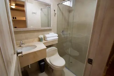 a bathroom with a toilet and a shower and a sink at Life is Good Cartagena Hostel in Cartagena de Indias
