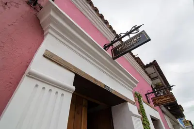 a pink building with a sign above a door at Life is Good Cartagena Hostel in Cartagena de Indias