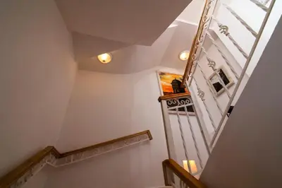 a staircase in a house with a cat sitting on a shelf at Life is Good Cartagena Hostel in Cartagena de Indias