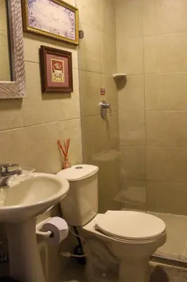 a bathroom with a toilet and a sink and a shower at Life is Good Cartagena Hostel in Cartagena de Indias