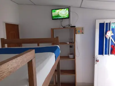 a bedroom with a bunk bed with a tv on the wall at Gran Muelle Hotel in San Bernardo del Viento