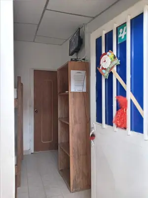 a room with a door and a book shelf at Gran Muelle Hotel in San Bernardo del Viento