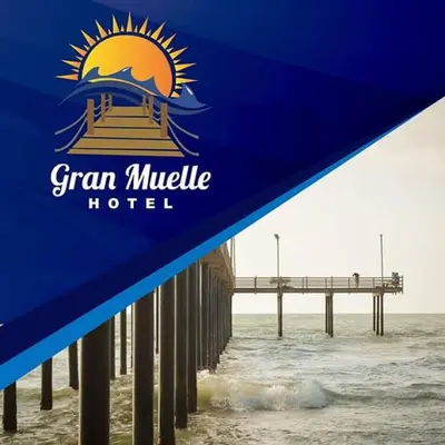 a blue hotel sign with a pier in the water at Gran Muelle Hotel in San Bernardo del Viento