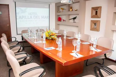 a conference room with a large wooden table and chairs at Hotel Capilla del Mar in Cartagena de Indias