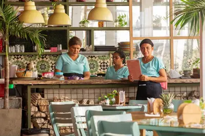 three women standing behind a counter in a restaurant at Hotel Barahona Cartagena in Cartagena de Indias