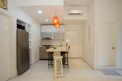 a kitchen with a sink and a table in a room at Hotel Barahona Cartagena in Cartagena de Indias