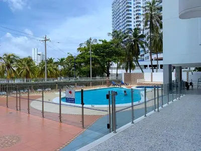 a swimming pool with a fence around it at Apartamento con hermosa vista y cerca de playas in Cartagena de Indias