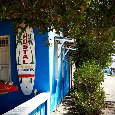 a blue building with a surfboard on the side of it at Galerazambahostal in Galerazamba