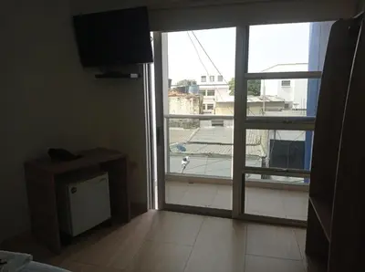 a room with a large window and a television at Hotel Damys in Sincelejo