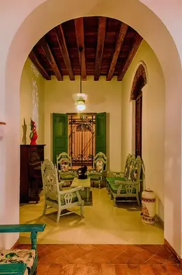 a living room with chairs and a table at Casa D´Remedios La Bella Hotel Boutique in Ciénaga