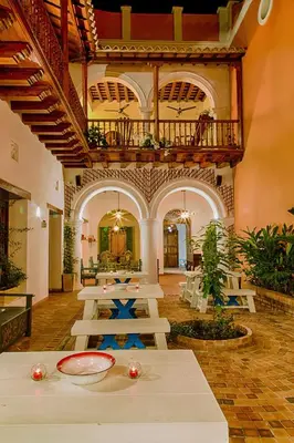 a large room with tables and chairs in a building at Casa D´Remedios La Bella Hotel Boutique in Ciénaga