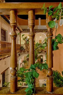 a largeoyer with wooden columns and a staircase at Casa D´Remedios La Bella Hotel Boutique in Ciénaga
