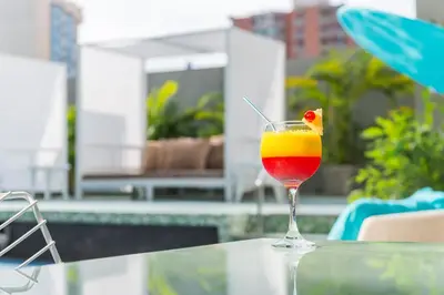 a drink in a glass sitting on a table at Country International Hotel in Barranquilla