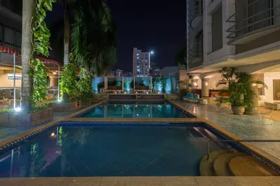 a swimming pool in a hotel at night at Country International Hotel in Barranquilla