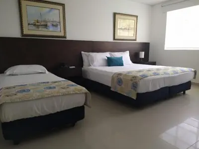a bedroom with two beds and a window at San Martin Cartagena in Cartagena de Indias