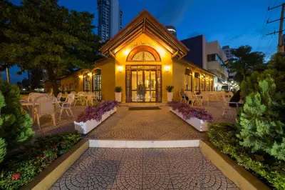 a building with tables and chairs in front of it at San Martin Cartagena in Cartagena de Indias