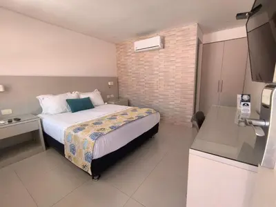 a hotel room with a bed and a television at San Martin Cartagena in Cartagena de Indias