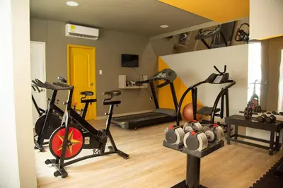 a gym with several exercise bikes in a room at Hotel American Golf in Barranquilla