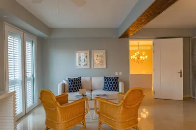 a living room with a couch and chairs and a table at Casa La Merced by Mustique in Cartagena de Indias