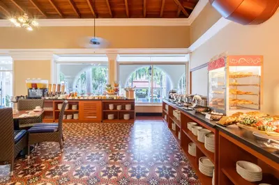 a large kitchen with a counter with dishes on it at Hotel El Prado in Barranquilla