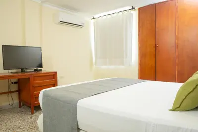 a bedroom with a bed and a tv on a dresser at Ayenda 1313 Barahona 72 in Barranquilla