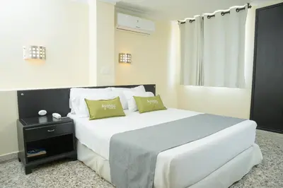 a bedroom with a large white bed with two pillows at Ayenda 1313 Barahona 72 in Barranquilla