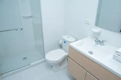 a bathroom with a toilet and a shower and a sink at Ayenda 1313 Barahona 72 in Barranquilla