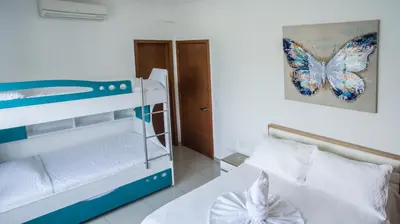 a bedroom with a bunk bed with a butterfly picture on the wall at OCEAN VIEW SPACIOUS PENTHOUSES WITH BIG TERRACES AND OVER 318 Square Meters in Cartagena de Indias