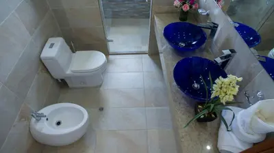 a bathroom with a white toilet and a sink at OCEAN VIEW SPACIOUS PENTHOUSES WITH BIG TERRACES AND OVER 318 Square Meters in Cartagena de Indias