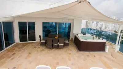 a room with a hot tub and a table and chairs at OCEAN VIEW SPACIOUS PENTHOUSES WITH BIG TERRACES AND OVER 318 Square Meters in Cartagena de Indias