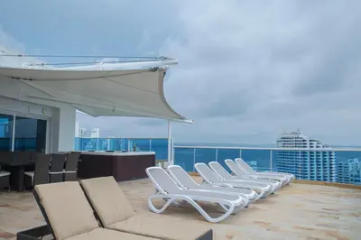 a row of lounge chairs on the roof of a cruise ship at OCEAN VIEW SPACIOUS PENTHOUSES WITH BIG TERRACES AND OVER 318 Square Meters in Cartagena de Indias