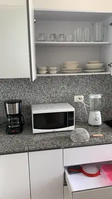 a microwave on a counter in a kitchen at 41st Fl Beach Condo in Bocagrande in Cartagena de Indias