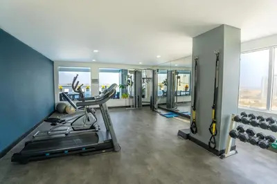 a fitness room with a gym with a treadmill and weights at GHL Hotel Barranquilla in Barranquilla