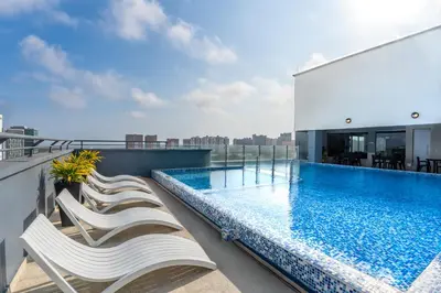 a balcony with a swimming pool on top of a building at GHL Hotel Barranquilla in Barranquilla