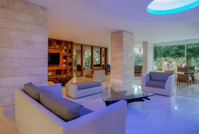 a living room with couches and a glass table at GHL Relax Hotel Costa Azul in Santa Marta