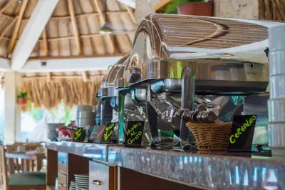 a coffee machine sitting on top of a counter at GHL Relax Hotel Costa Azul in Santa Marta
