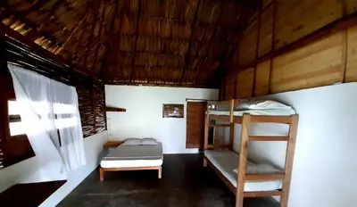 a room with two bunk beds and a window at Ecohotel Kocoluu in San Bernardo del Viento