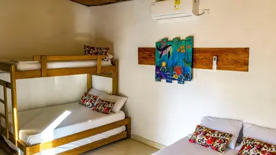 a room with two bunk beds in a house at Ecohotel Kocoluu in San Bernardo del Viento