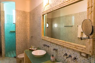 a bathroom with a sink and a mirror at Hotel Casa La Tablada Manga in Cartagena de Indias