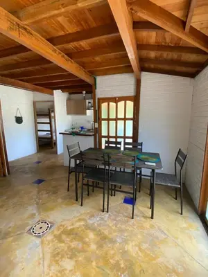 a dining room with a table and chairs in a room at El palmar azul in San Bernardo del Viento