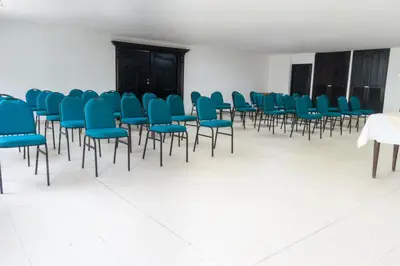 a large room with blue chairs and a table at Hotel Caribe Plaza Barranquilla in Barranquilla