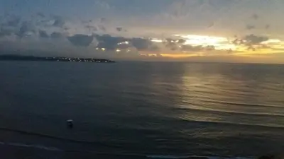 a sunset over the ocean with the sun setting at Caribe a Vista in Cartagena de Indias