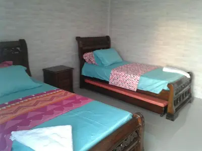 two twin beds in a room with at Caribe a Vista in Cartagena de Indias