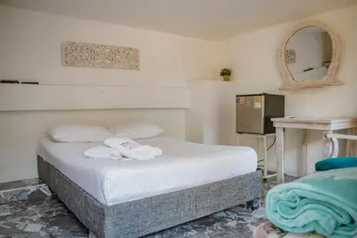 a bedroom with a bed with towels on it at Hotel La Casona de Getsemani in Cartagena de Indias