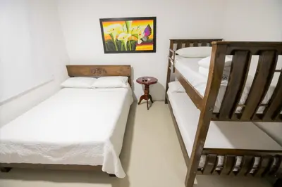 a room with two bunk beds and a staircase at Hotel La Casona de Getsemani in Cartagena de Indias